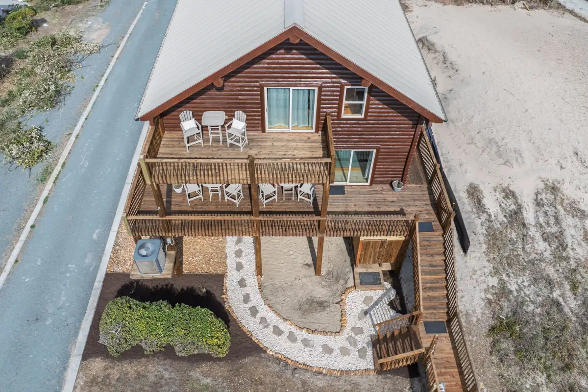 Completed multi-level wood deck with dining and lounge areas at a coastal home