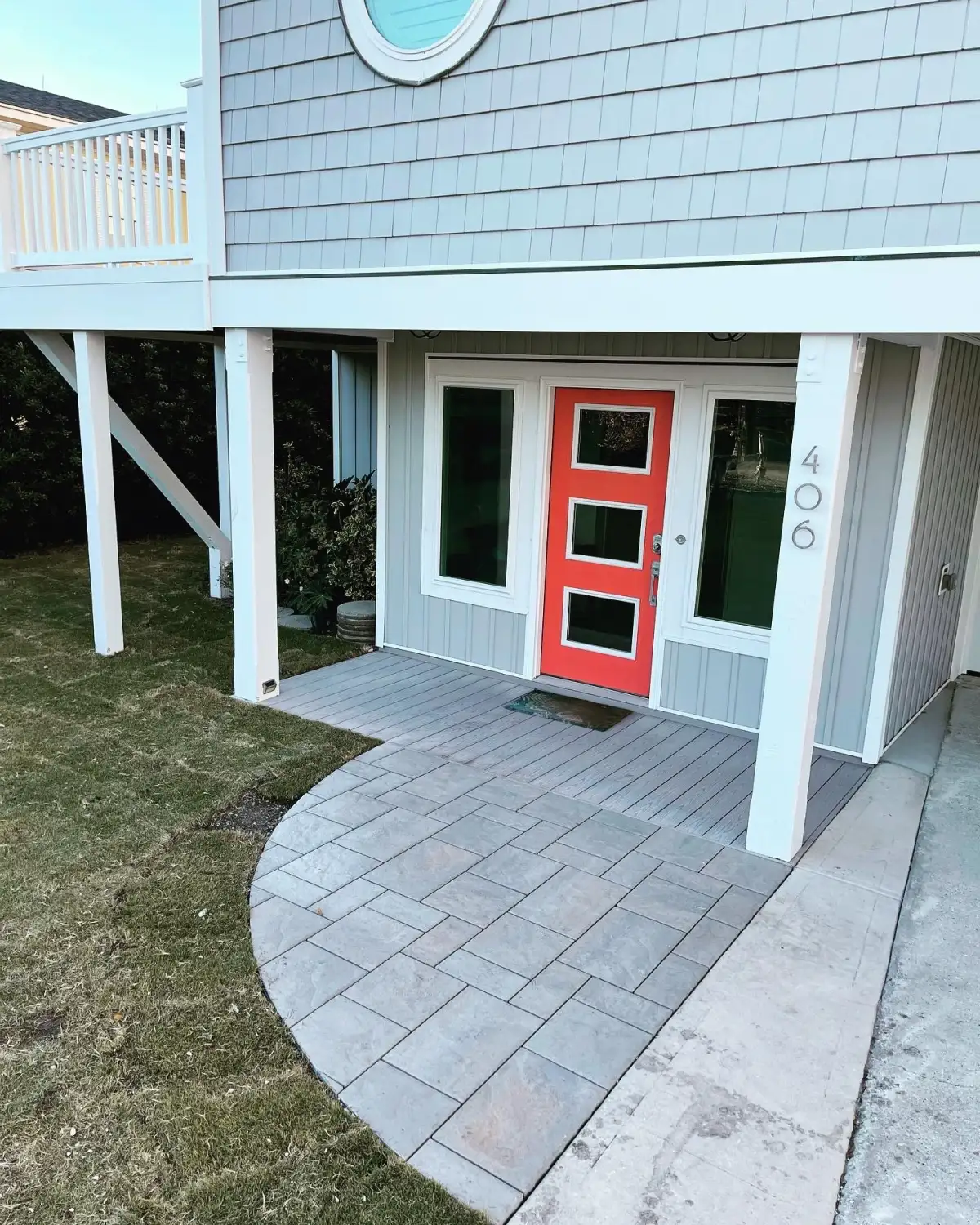 Large-format Belgard paver patio with fire pit and seating wall at a Porters Neck Wilmington NC home